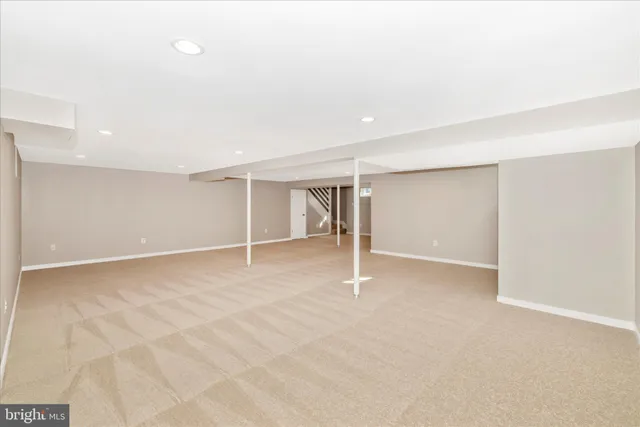 an empty room with closet and a window