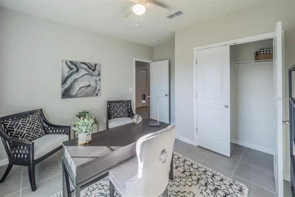 a dining room with furniture and wooden floor