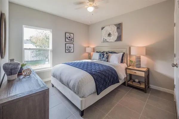 a bedroom with a bed and a table in it with window