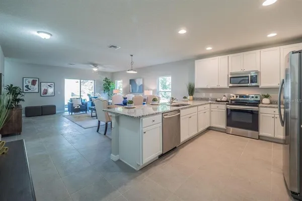 a kitchen with kitchen island a sink stainless steel appliances and cabinets