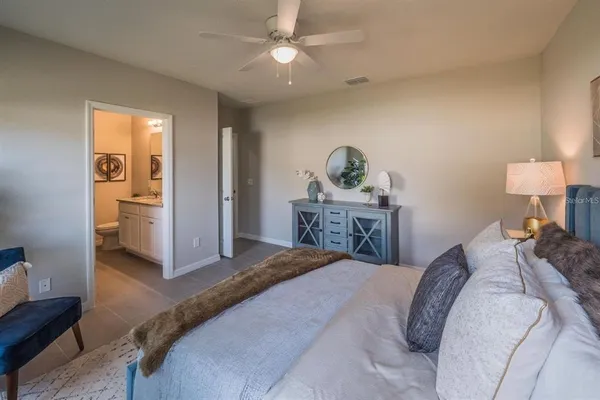 a bedroom with a bed and a chandelier