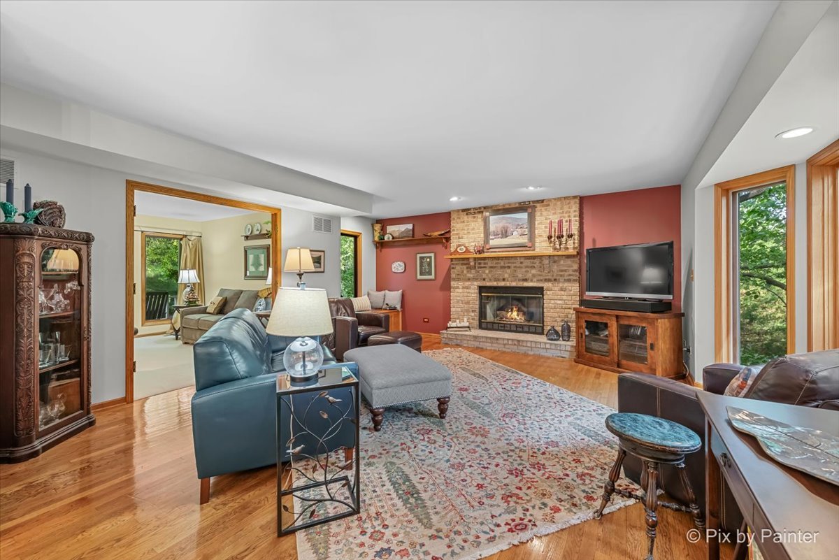 28971 Fox Street Cary, IL 60013 - Photo 15 of 51 a living room with furniture a flat screen tv and a fireplace