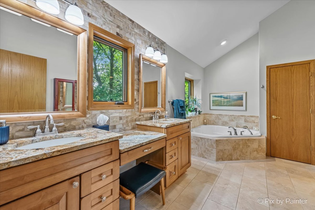 28971 Fox Street Cary, IL 60013 - Photo 22 of 51 a spacious bathroom with a granite countertop tub sink and mirror