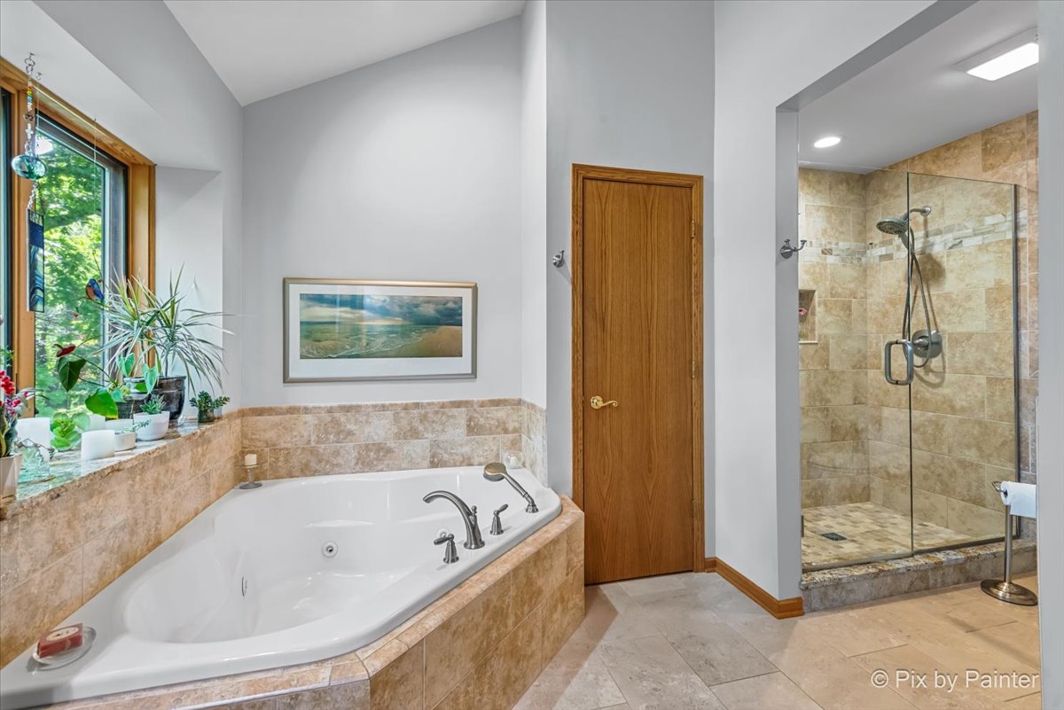 28971 Fox Street Cary, IL 60013 - Photo 23 of 51 a bathroom with a bathtub and a shower