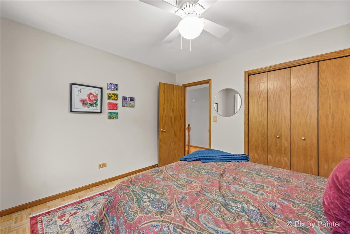 28971 Fox Street Cary, IL 60013 - Photo 25 of 51 a bedroom with a large bed and a chandelier