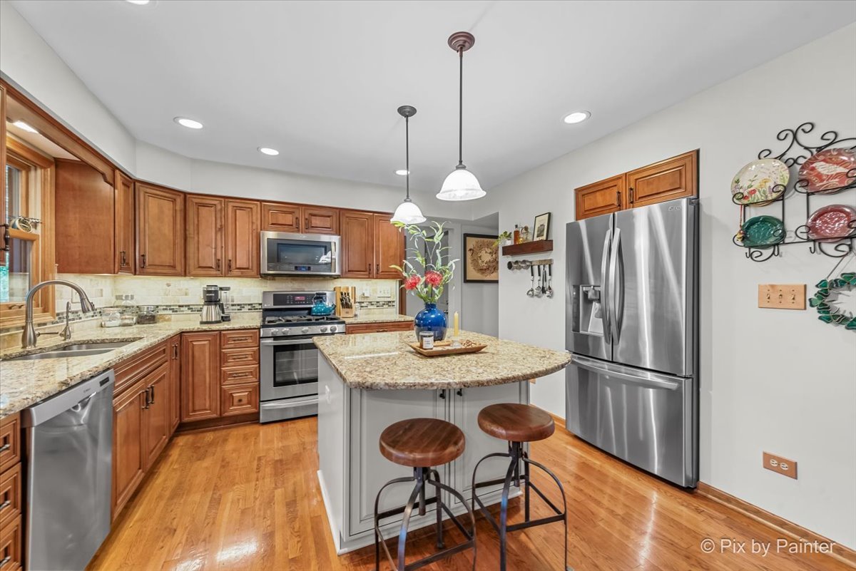 28971 Fox Street Cary, IL 60013 - Photo 10 of 51 a kitchen with granite countertop a refrigerator a stove top oven a sink and dishwasher