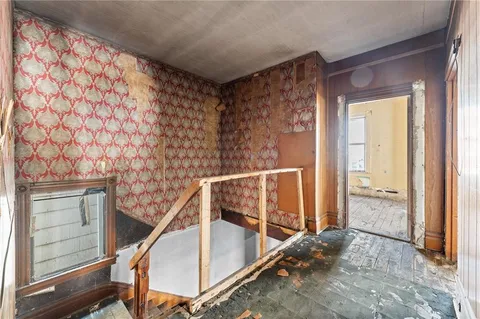 a view of a livingroom with furniture window and wooden floor