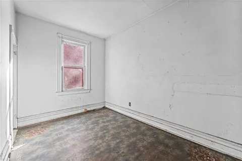 a view of a livingroom with wooden floor and furniture