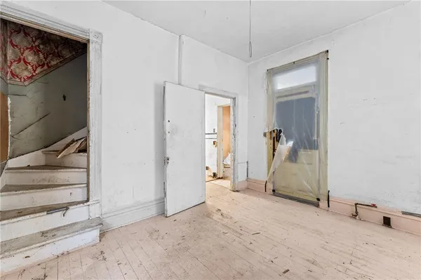 a view of a livingroom with wooden floor and a ceiling fan