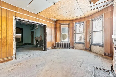 a view of an empty room with a fireplace