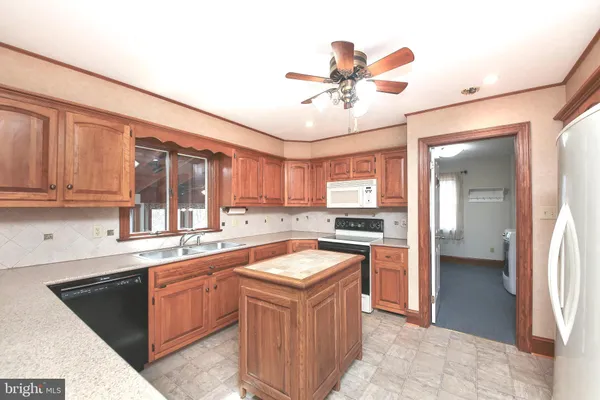 a kitchen with a stove sink and cabinets