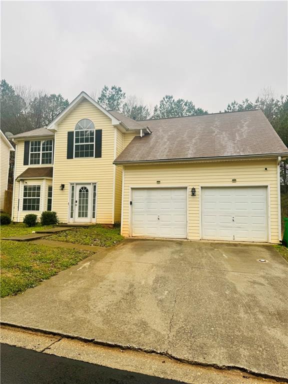 2702 Rambling Way Lithonia, GA 30058 - Photo 1 of 1 a view of a white house with a yard and a large window