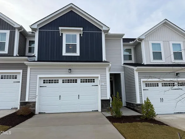 a front view of a house with a garage