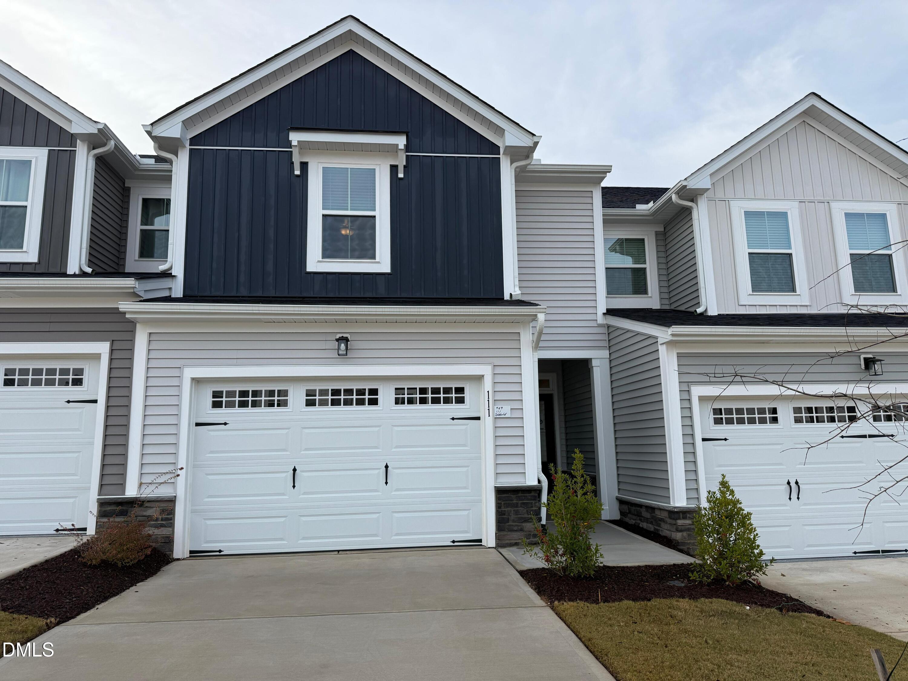 a front view of a house with a garage