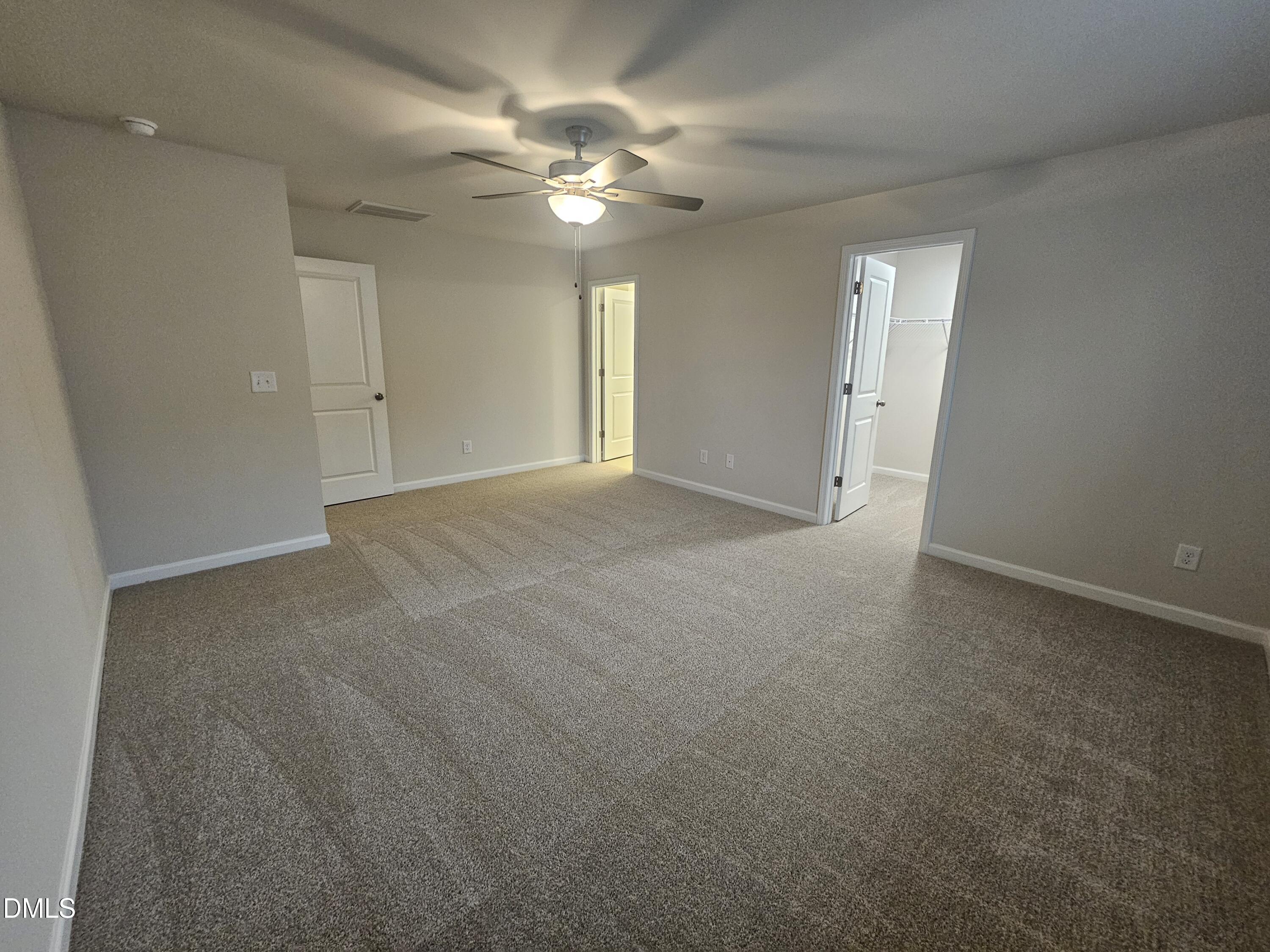 111 Siebold Street Garner, NC 27529 - Photo 15 of 25 a view of an empty room with a chandelier fan