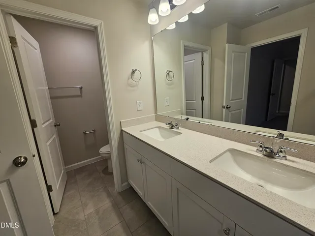 a bathroom with a glass shower door and sink