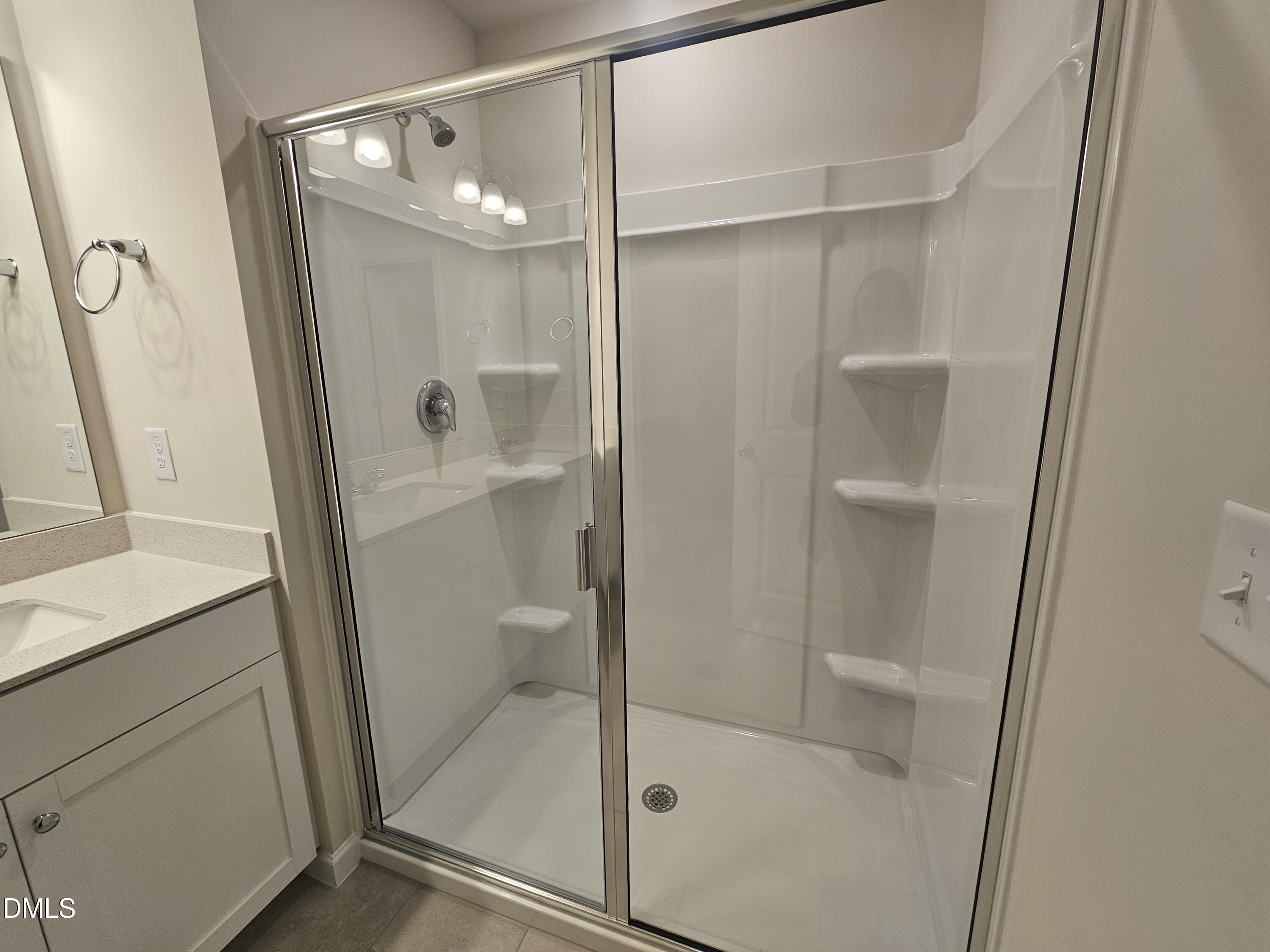 111 Siebold Street Garner, NC 27529 - Photo 19 of 25 a bathroom with a glass shower door and sink