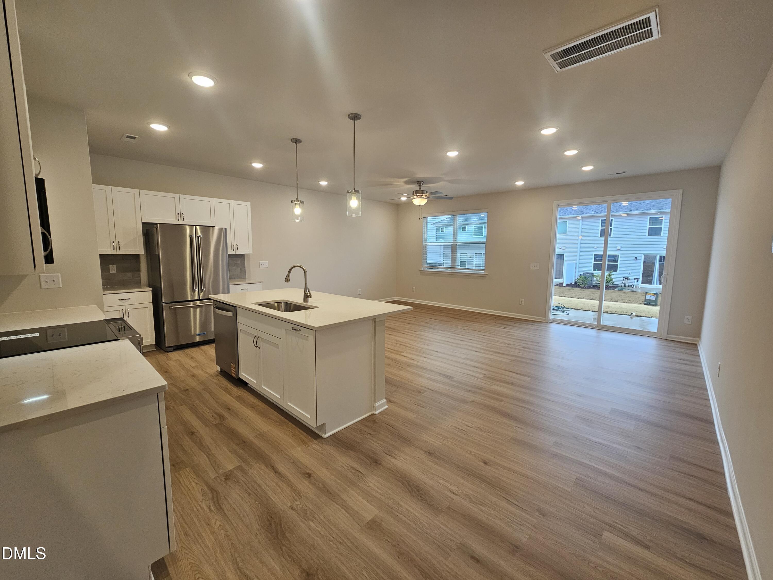 111 Siebold Street Garner, NC 27529 - Photo 2 of 25 a large kitchen with stainless steel appliances kitchen island a large counter top and a wooden floors