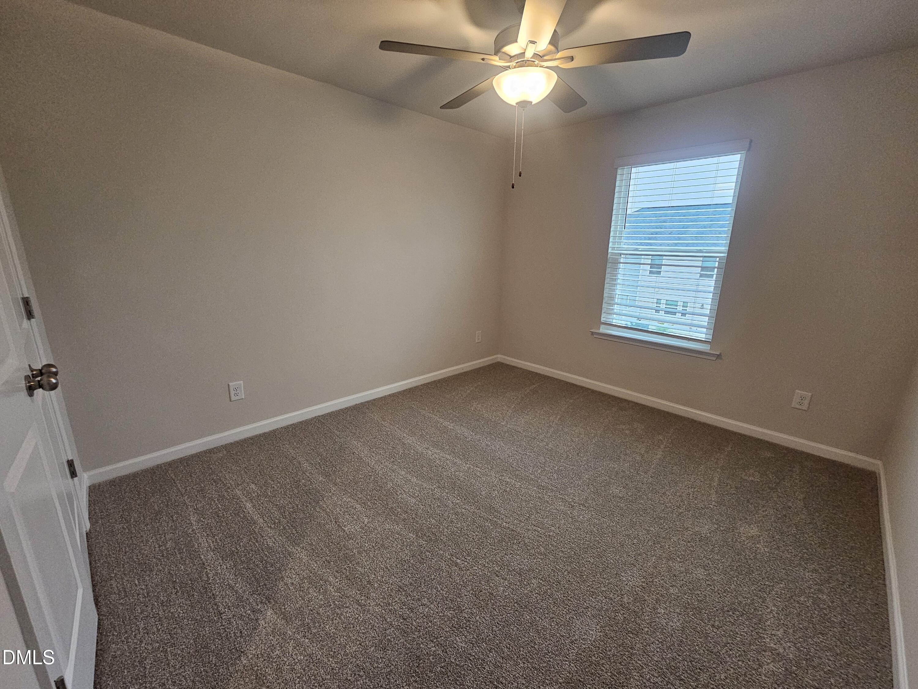 111 Siebold Street Garner, NC 27529 - Photo 22 of 25 an empty room with a window and a fan