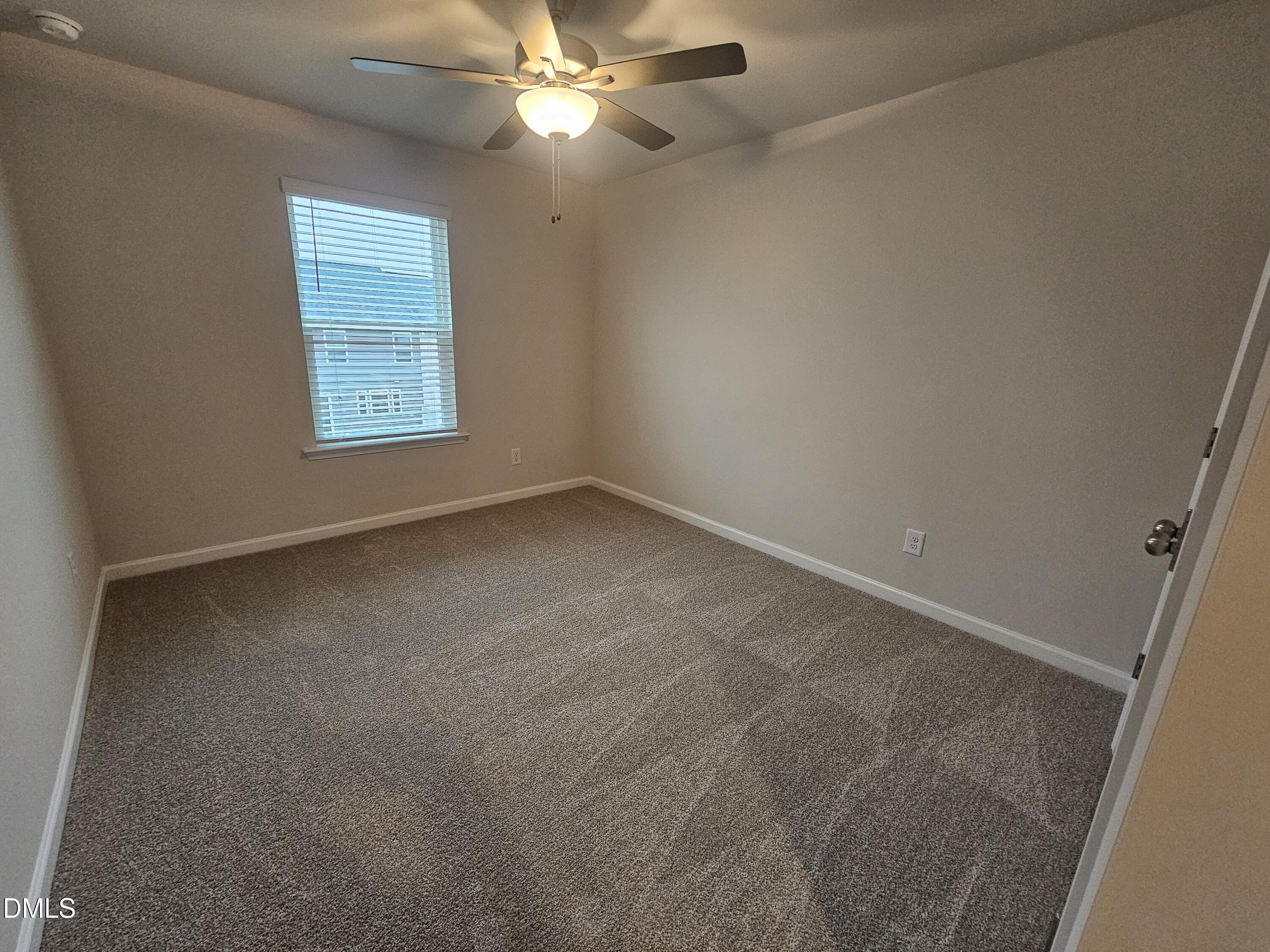 111 Siebold Street Garner, NC 27529 - Photo 25 of 25 an empty room with a window and a fan