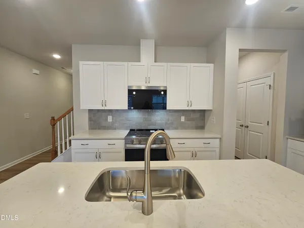 a kitchen with a sink and cabinets