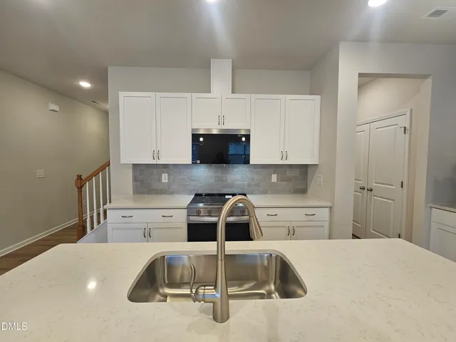 a kitchen with a sink and cabinets