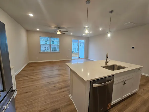 a kitchen with a sink and chandelier