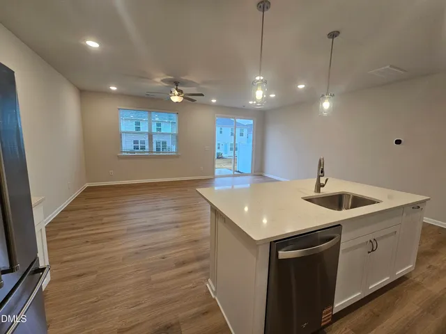 a kitchen with a sink and chandelier
