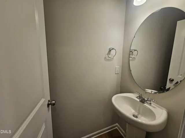 a view of kitchen with kitchen island granite countertop wooden floor stainless steel appliances and a fireplace