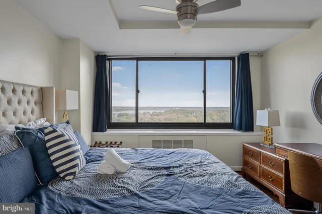 a bedroom with a large bed and a large window