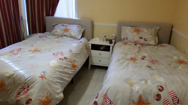 a bedroom with a bed and a painting on the wall