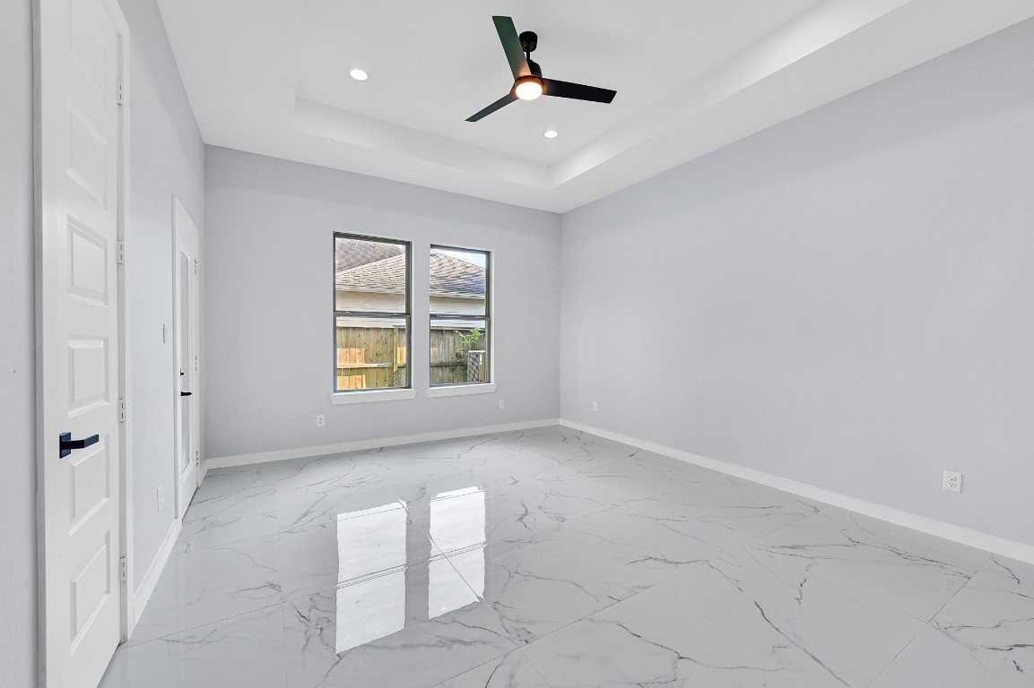 90 Burress Street, Unit B Houston, TX 77022 - Photo 17 of 31 an empty room with windows and fan