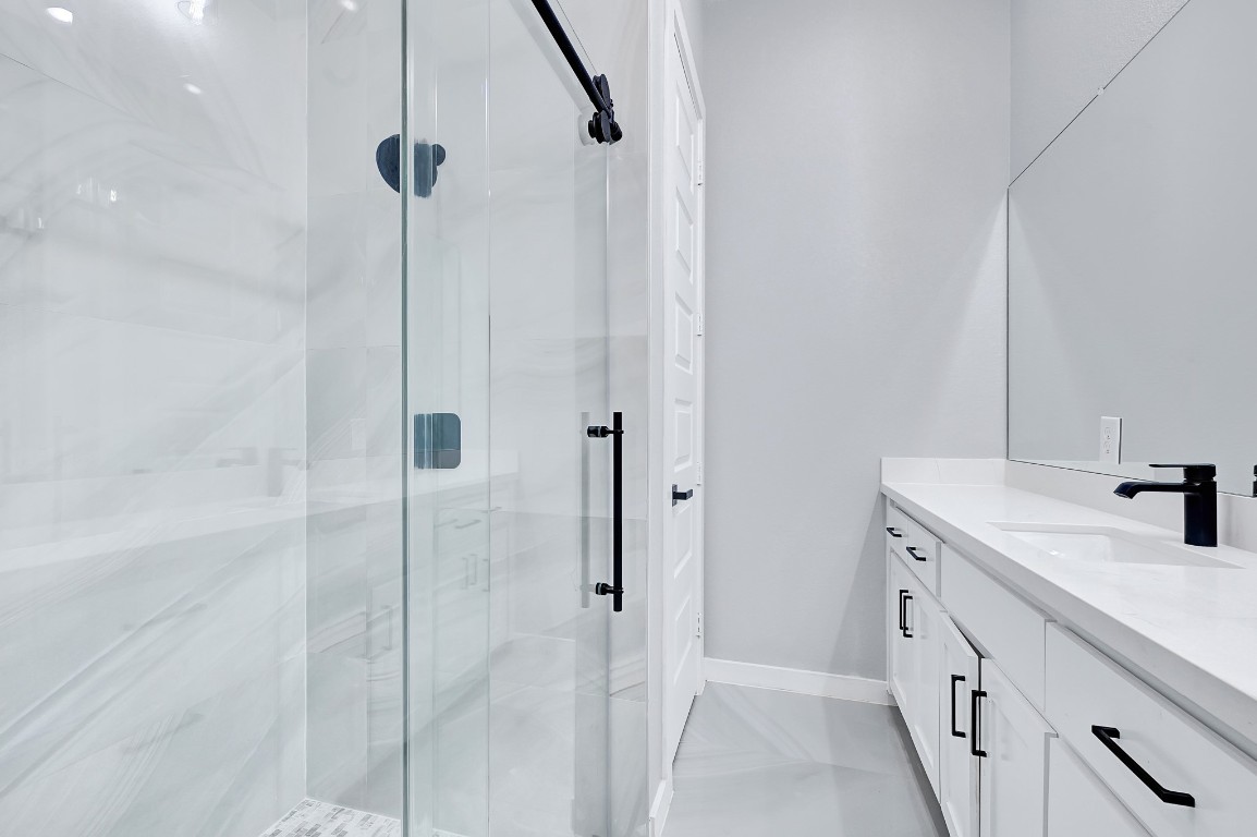 90 Burress Street, Unit B Houston, TX 77022 - Photo 20 of 31 a bathroom with a double vanity sink a mirror and a shower