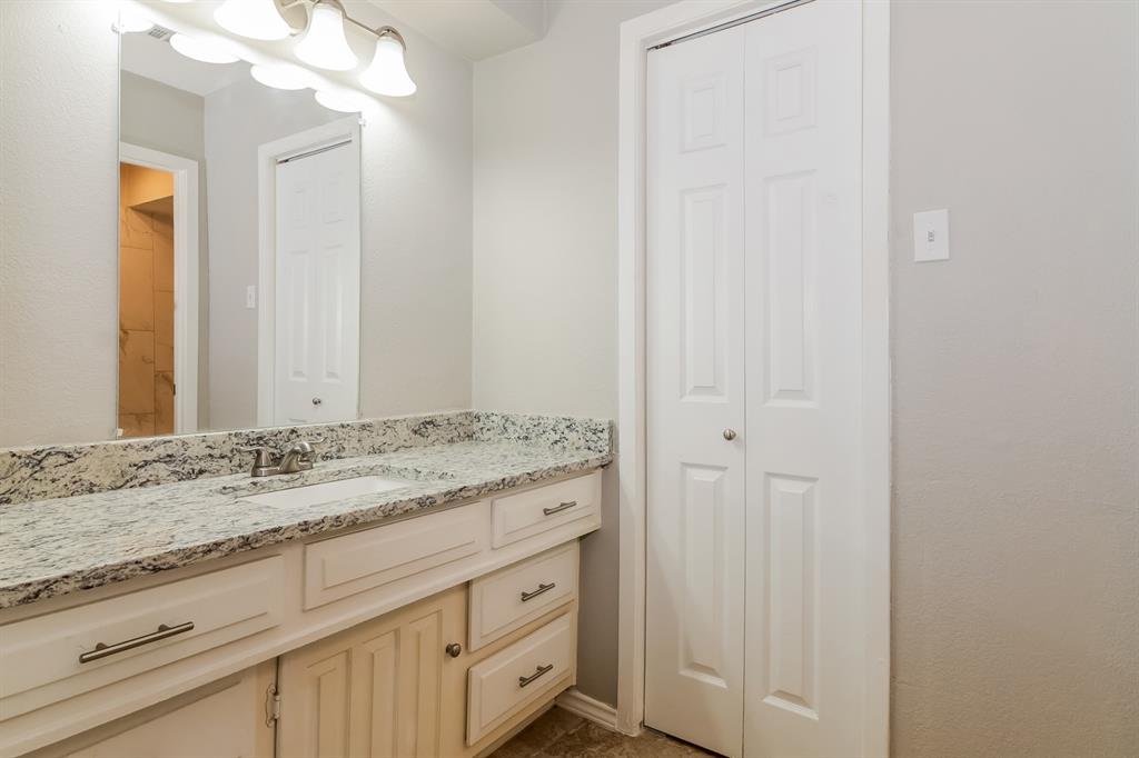 4821 Ashbrook Road Dallas, TX 75227 - Photo 11 of 21 a bathroom with a granite countertop sink and a mirror