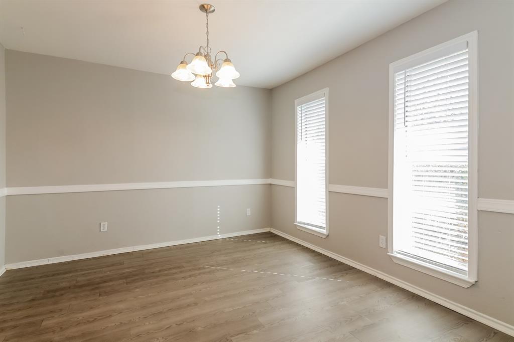 4821 Ashbrook Road Dallas, TX 75227 - Photo 18 of 21 an empty room with wooden floor and windows