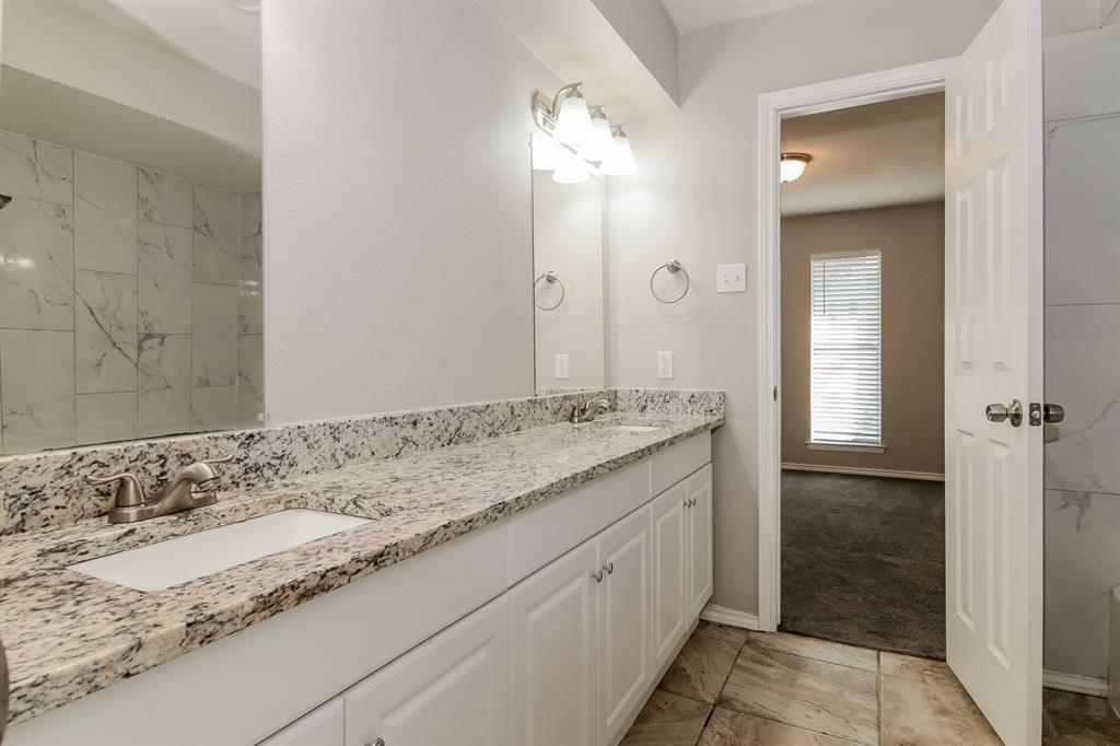 4821 Ashbrook Road Dallas, TX 75227 - Photo 19 of 21 a bathroom with a granite countertop sink and a mirror