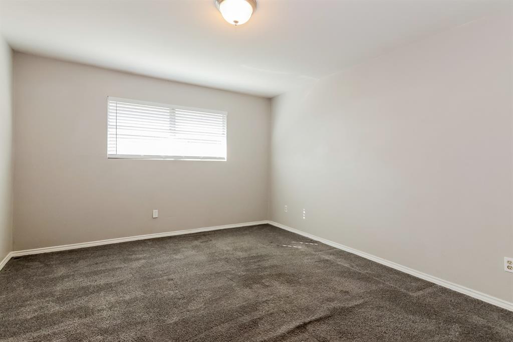 4821 Ashbrook Road Dallas, TX 75227 - Photo 9 of 21 an empty room with a window