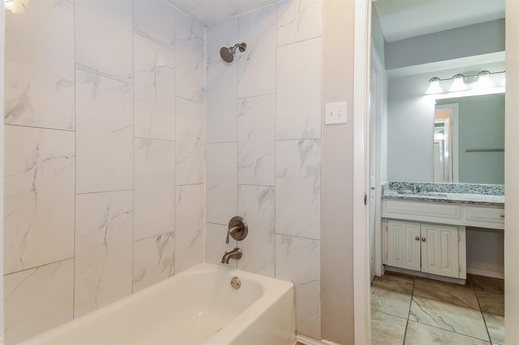 4821 Ashbrook Road Dallas, TX 75227 - Photo 10 of 21 a bathroom with a bathtub and a sink
