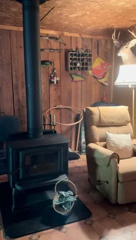 a living room with furniture a rug and wall paintings
