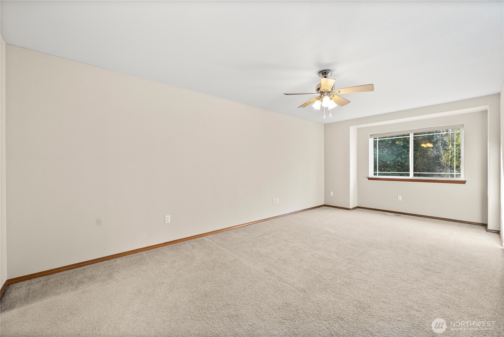 7626 78th Loop Northwest Olympia, WA 98502 - Photo 17 of 38 an empty room with a chandelier fan and windows