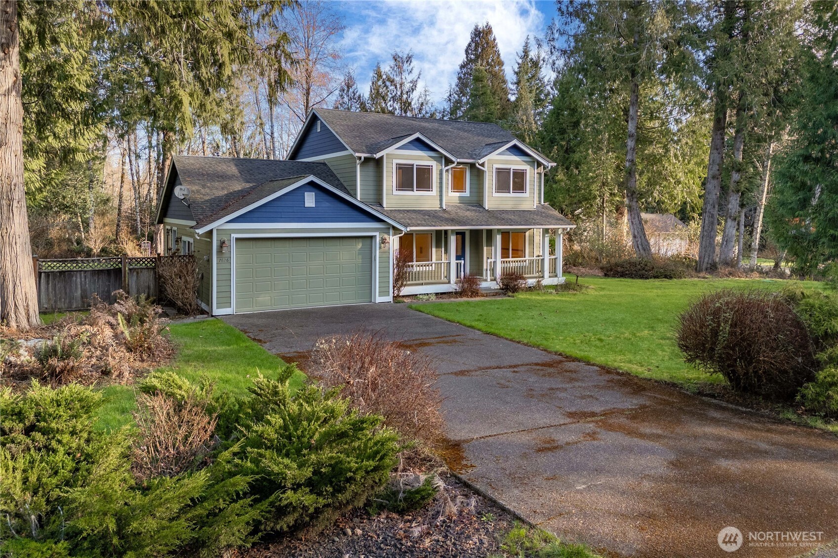7626 78th Loop Northwest Olympia, WA 98502 - Photo 2 of 38 a front view of a house with a garden
