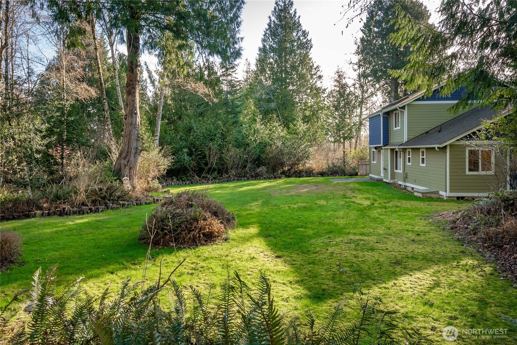 7626 78th Loop Northwest Olympia, WA 98502 - Photo 25 of 38 a view of a house with backyard and garden