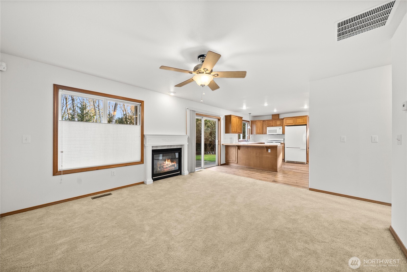7626 78th Loop Northwest Olympia, WA 98502 - Photo 6 of 38 a view of a livingroom with a fireplace and a chandelier fan