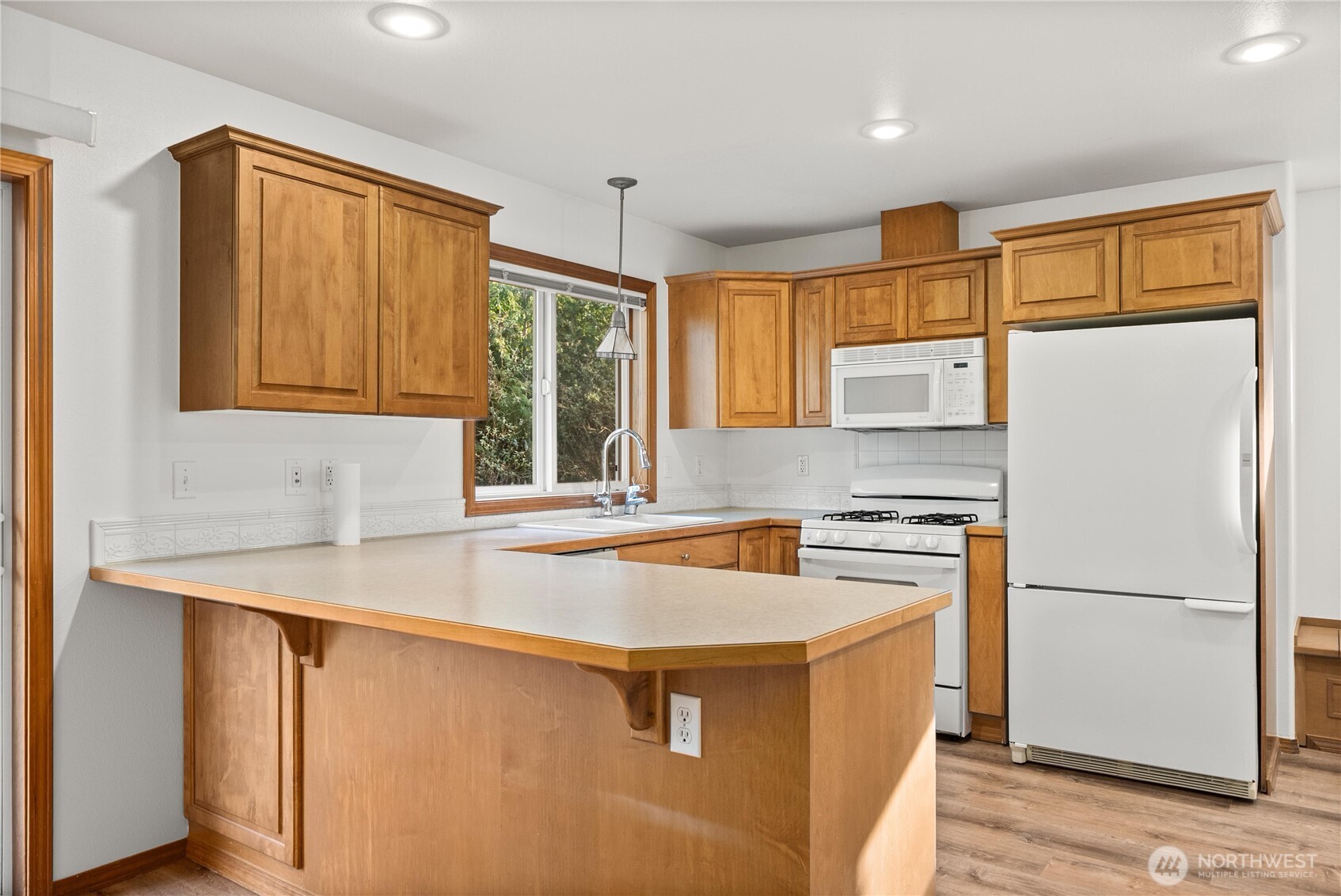 7626 78th Loop Northwest Olympia, WA 98502 - Photo 7 of 38 a kitchen with stainless steel appliances granite countertop a sink stove and refrigerator