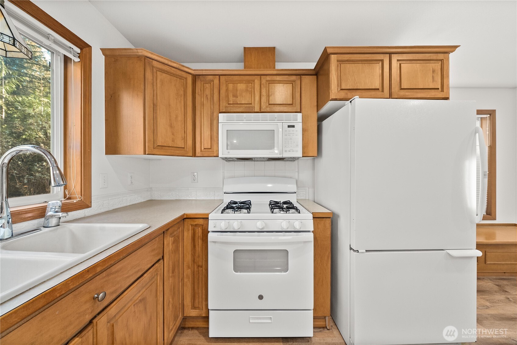 7626 78th Loop Northwest Olympia, WA 98502 - Photo 9 of 38 a kitchen with a stove top oven and a refrigerator