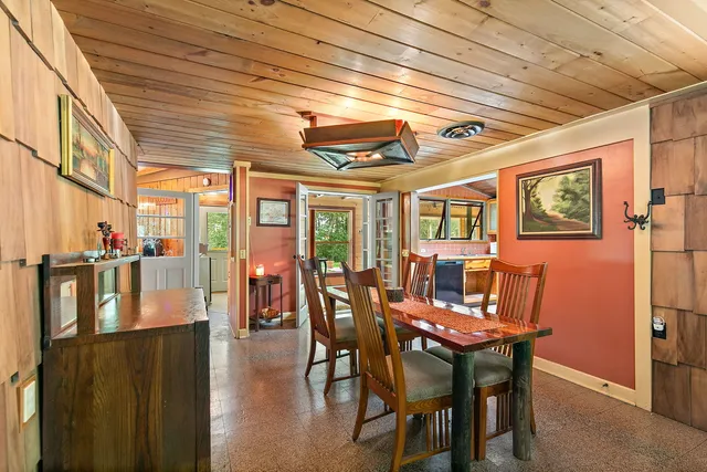 a dining room with furniture window and wooden floor