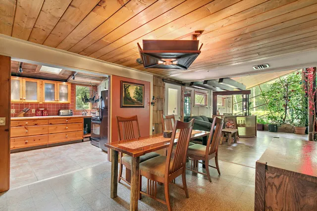 a dining room with furniture and wooden floor