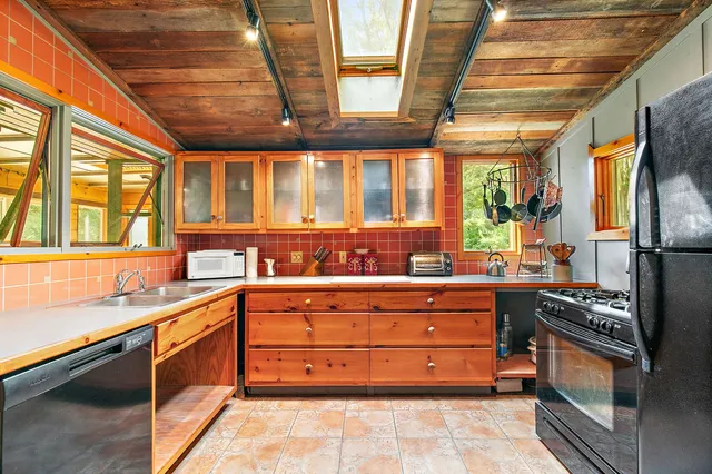 a kitchen with stainless steel appliances granite countertop a stove and a sink
