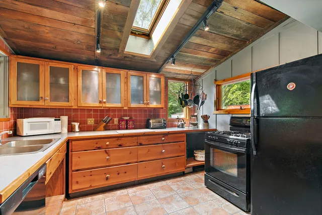 a kitchen with a refrigerator and a sink