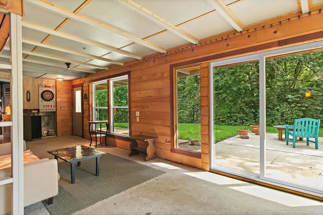 a balcony with furniture and a floor to ceiling window